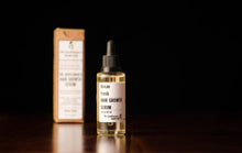 Bottle of hair growth serum in a transparent bottle